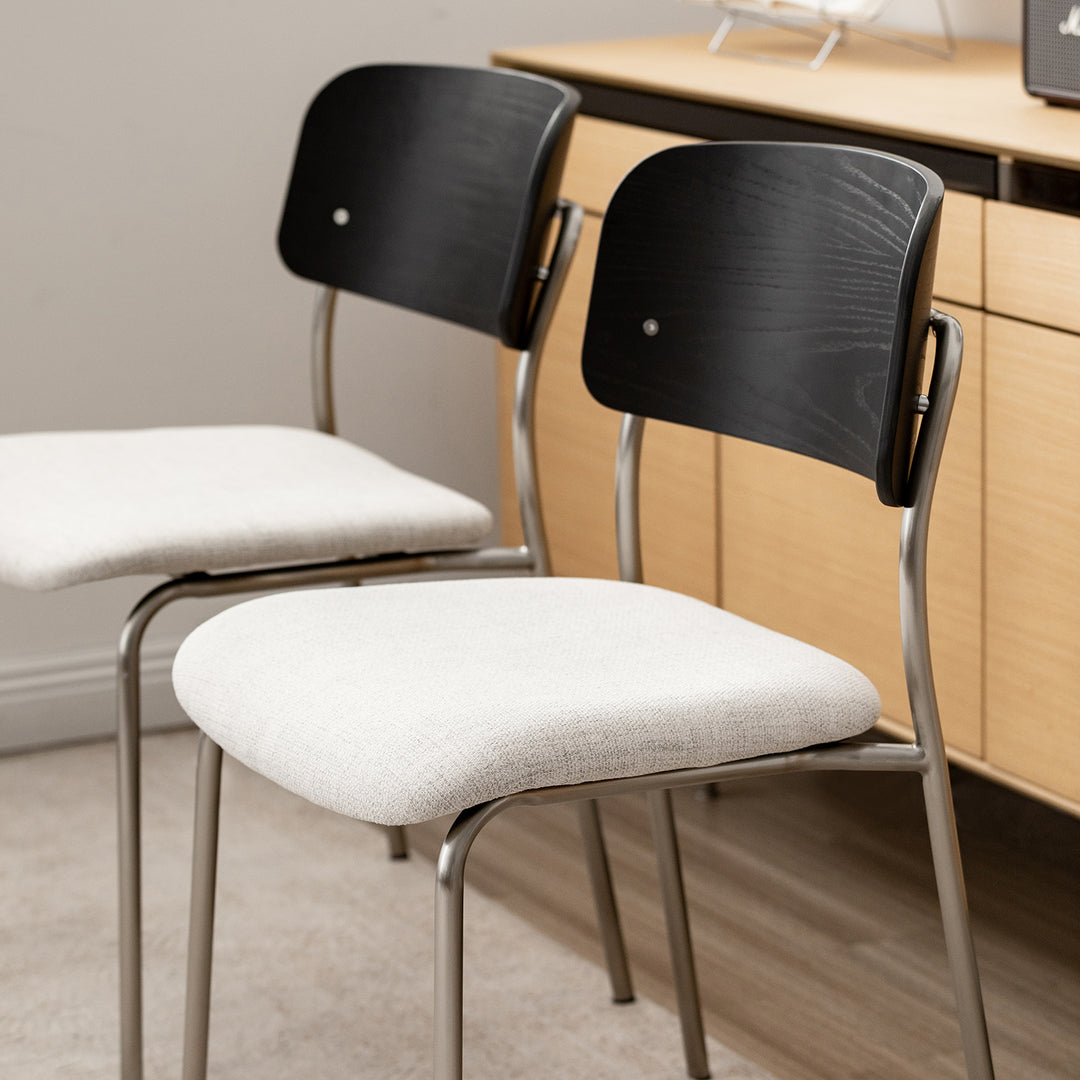Minimalist ash wood veneer cotton fabric dining chair black aeri in still life.