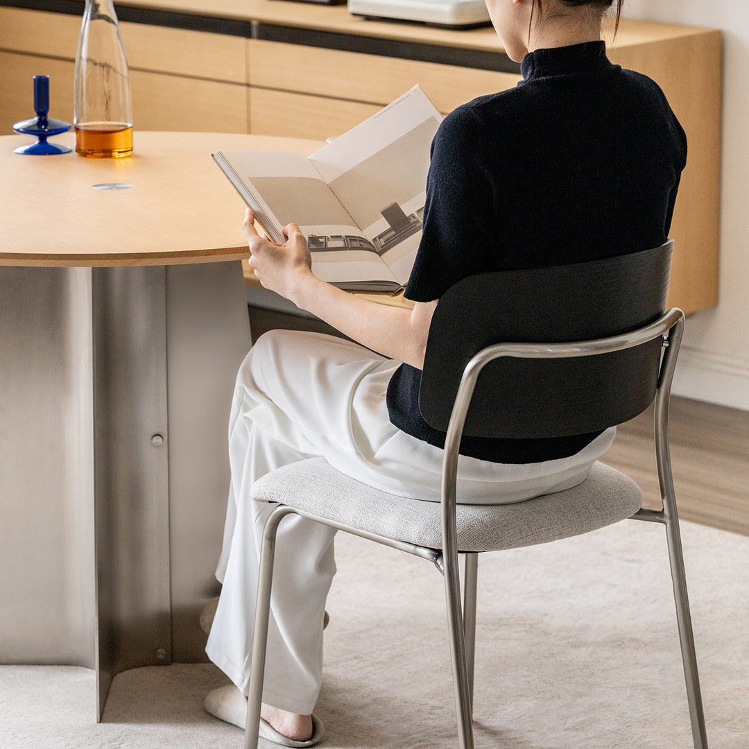 Minimalist ash wood veneer cotton fabric dining chair black aeri in real life style.