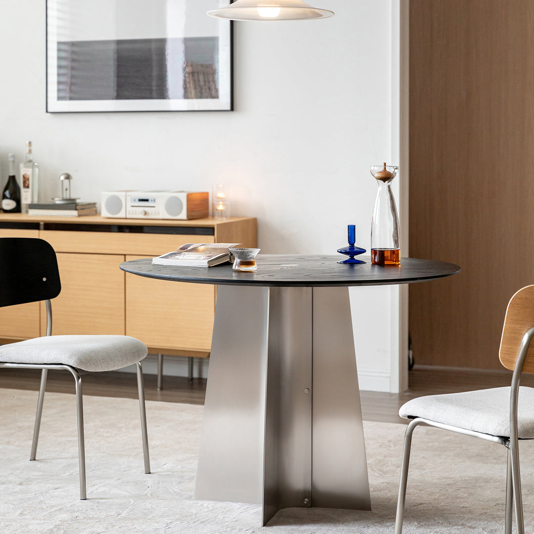 Minimalist ash wood veneer stainless steel round dining table black aeri in close up details.