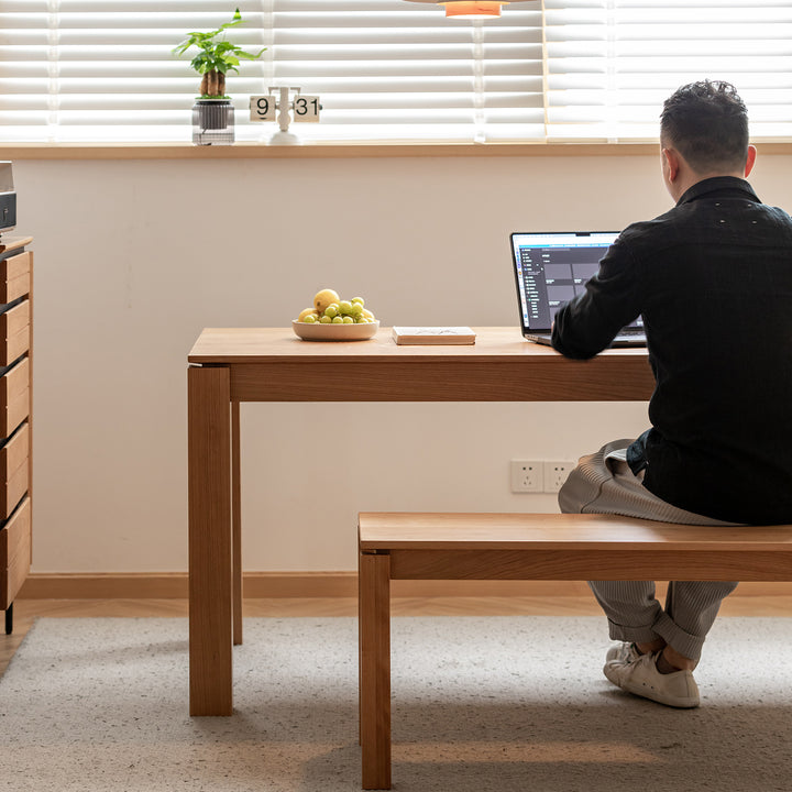 Minimalist cherry wood dining bench coastal in still life.