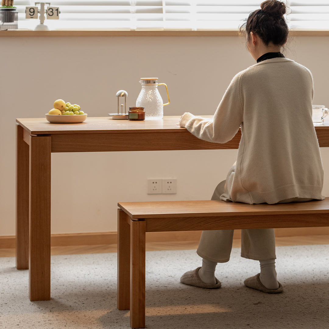 Minimalist cherry wood dining bench coastal material variants.
