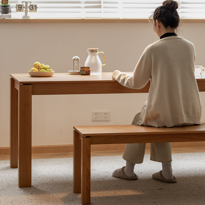 Minimalist cherry wood dining bench coastal material variants.
