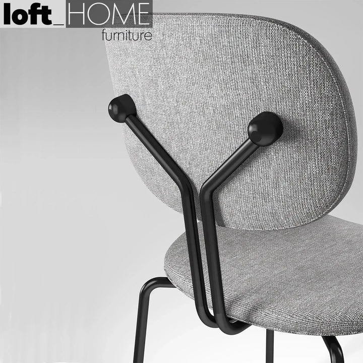 Industrial fabric dining chair et arm in panoramic view.