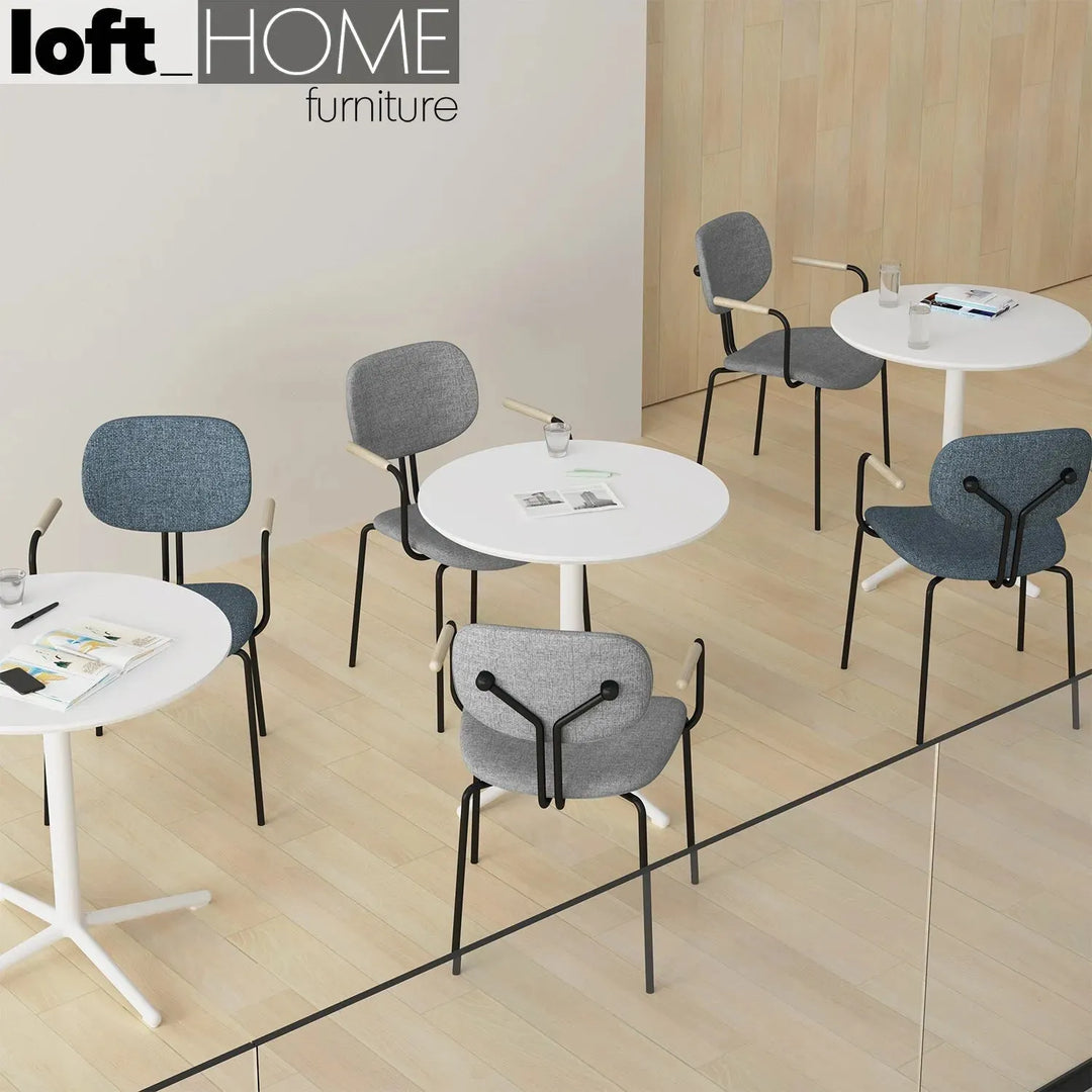 Industrial fabric dining chair et arm in close up details.