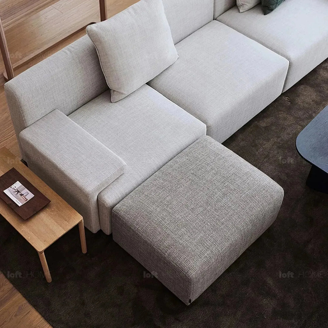 Minimalist fabric ottoman nemo with context.