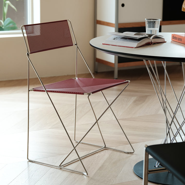 Minimalist steel dining chair x-line in panoramic view.