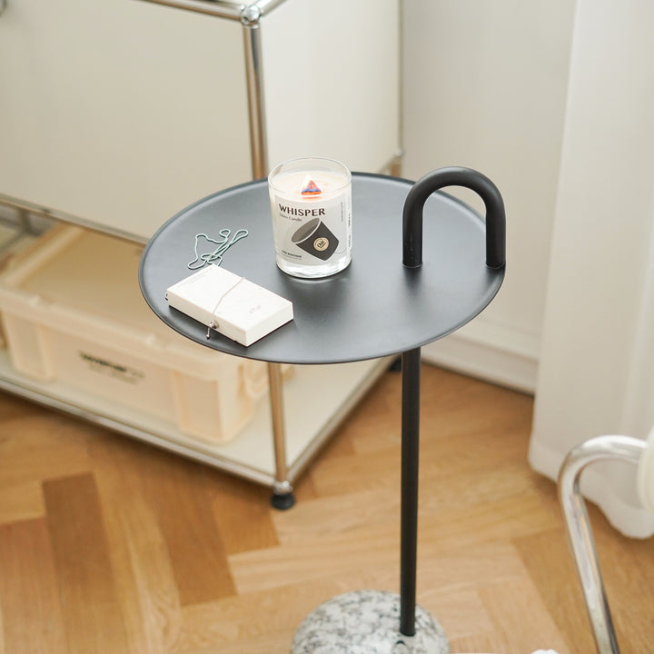 Minimalist steel marble side table loop in details.