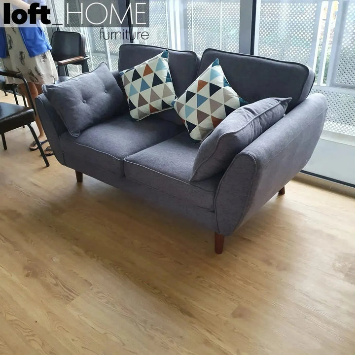 Scandinavian fabric 2 seater sofa henri in still life.