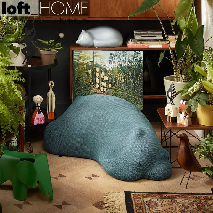 Contemporary knit fabric ottoman resting bear in real life style.