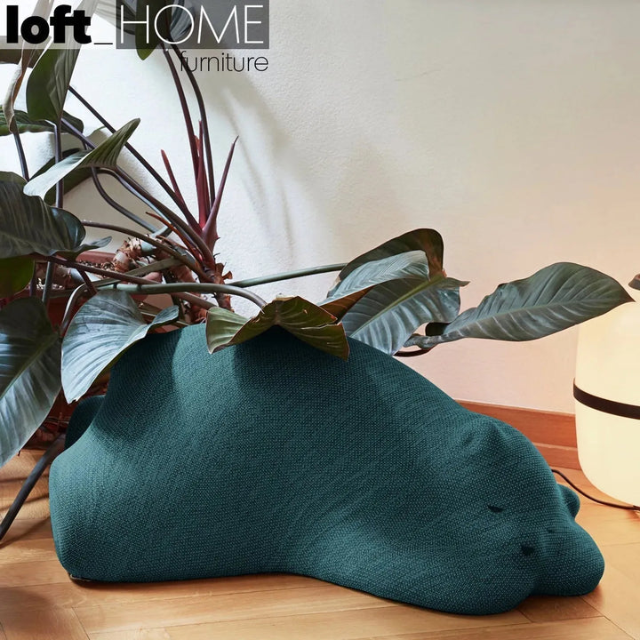 Contemporary knit fabric ottoman resting bear primary product view.