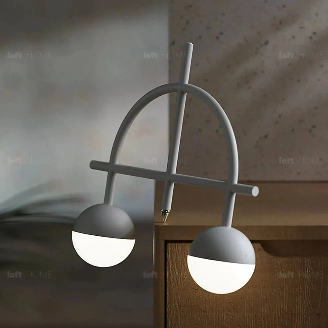 Contemporary steel charging table lamp balance in panoramic view.