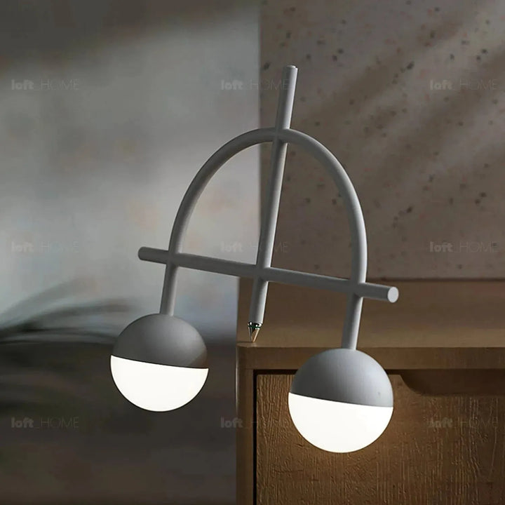 Contemporary steel charging table lamp balance in panoramic view.