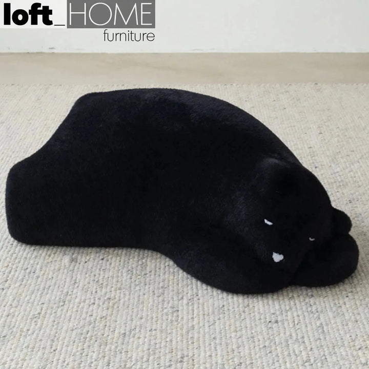 Contemporary velvet ottoman resting bear black primary product view.