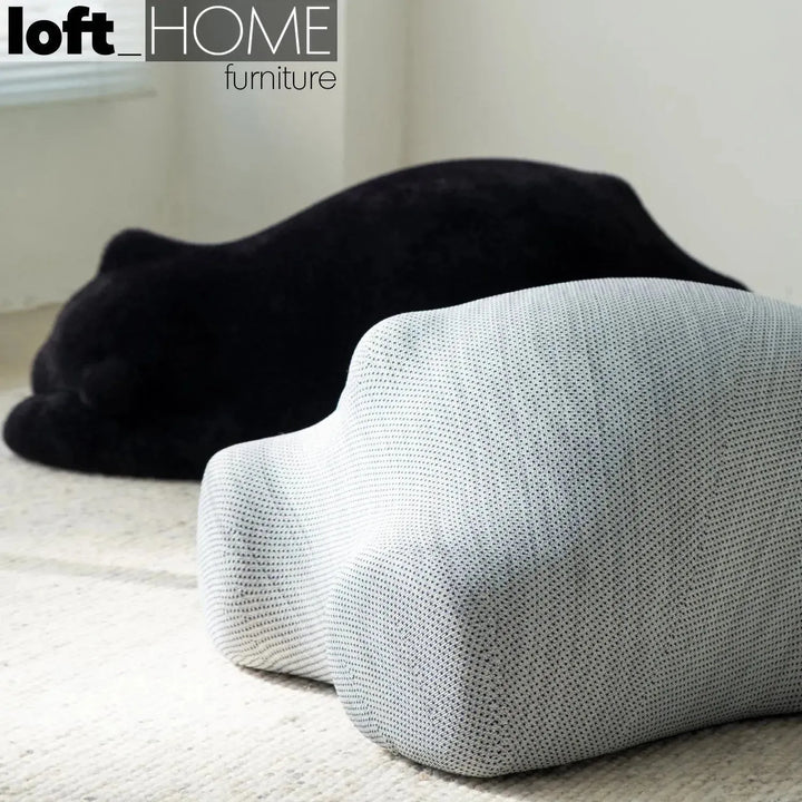 Contemporary velvet ottoman resting bear black in real life style.