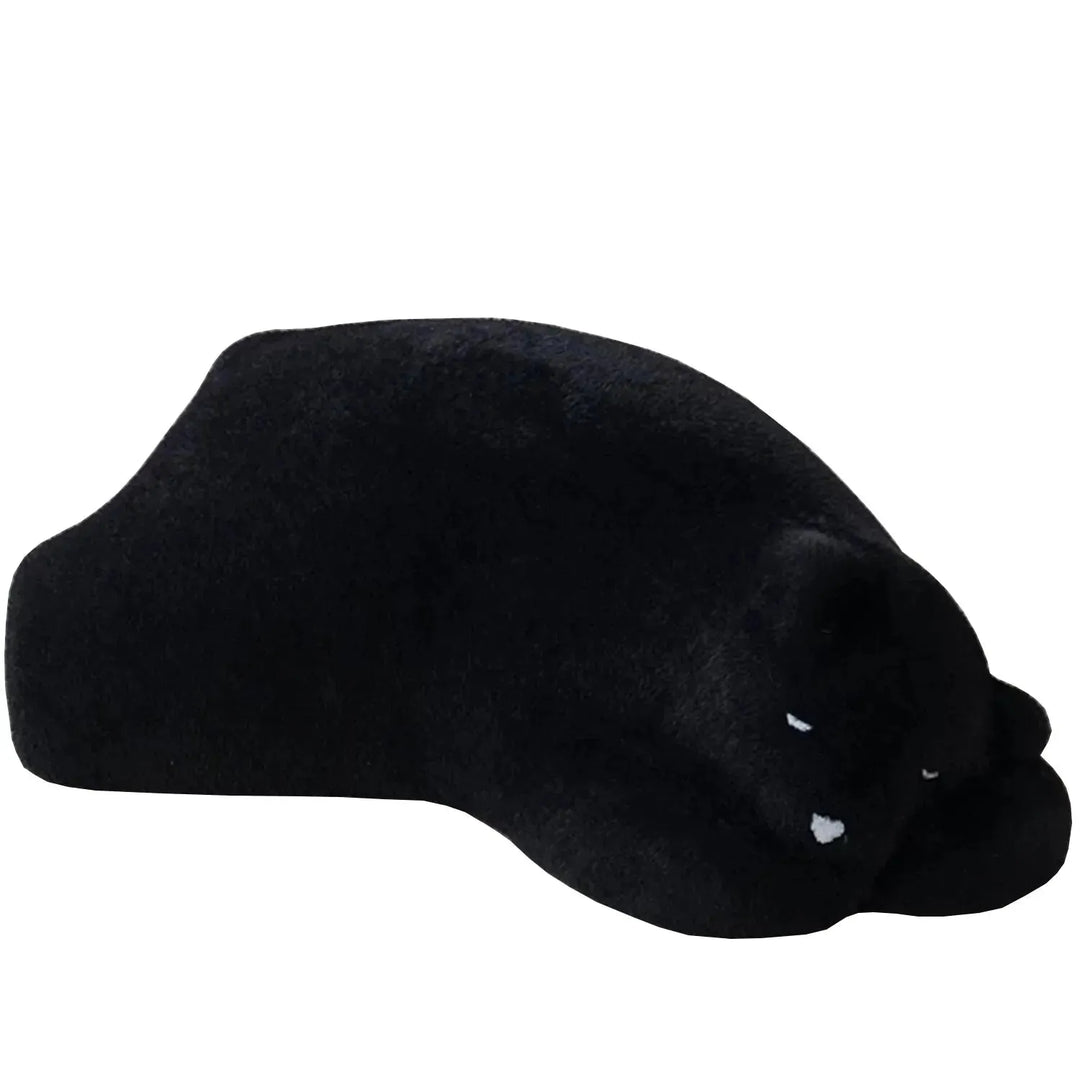 Contemporary velvet ottoman resting bear black in white background.