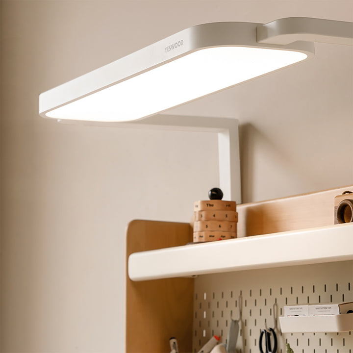 Scandinavian beech wood electric height adjustable kids study table with intergrated led light orbita in still life.