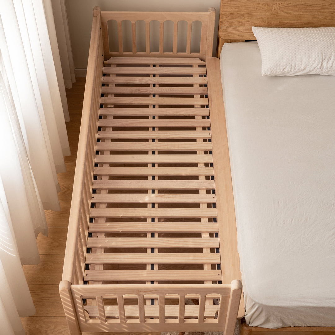 Scandinavian beech wood height adjustable kids sidecar bed with mattress set sova in panoramic view.