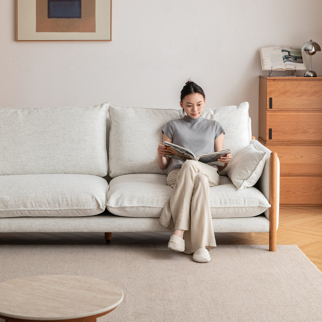 Scandinavian chenille velvet cherry wood 3 seater sofa sea salt in still life.