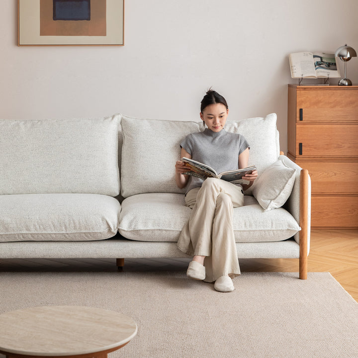 Scandinavian chenille velvet cherry wood 3 seater sofa sea salt in still life.