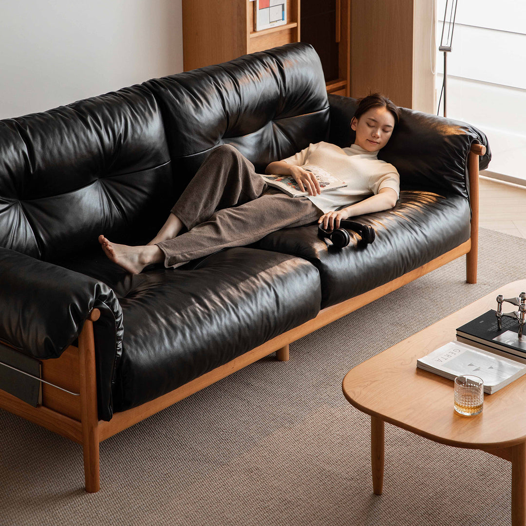 Scandinavian chenille velvet fabric cherry wood 3 seater sofa open backed in still life.