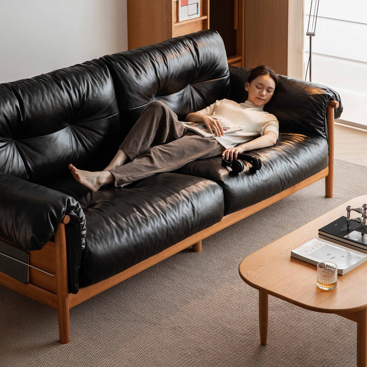 Scandinavian chenille velvet fabric cherry wood 3 seater sofa open backed in still life.