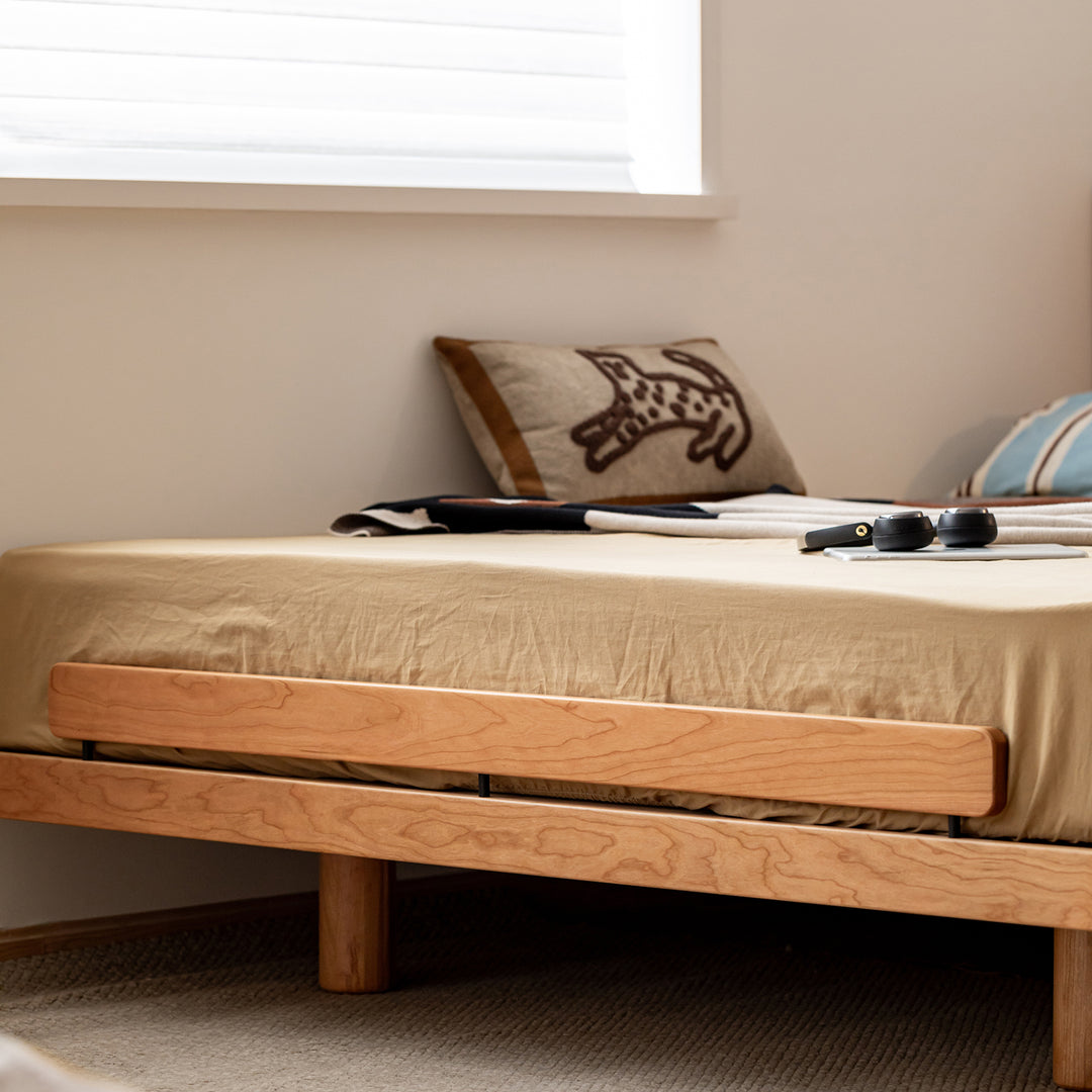 Scandinavian cherry wood bed small in still life.