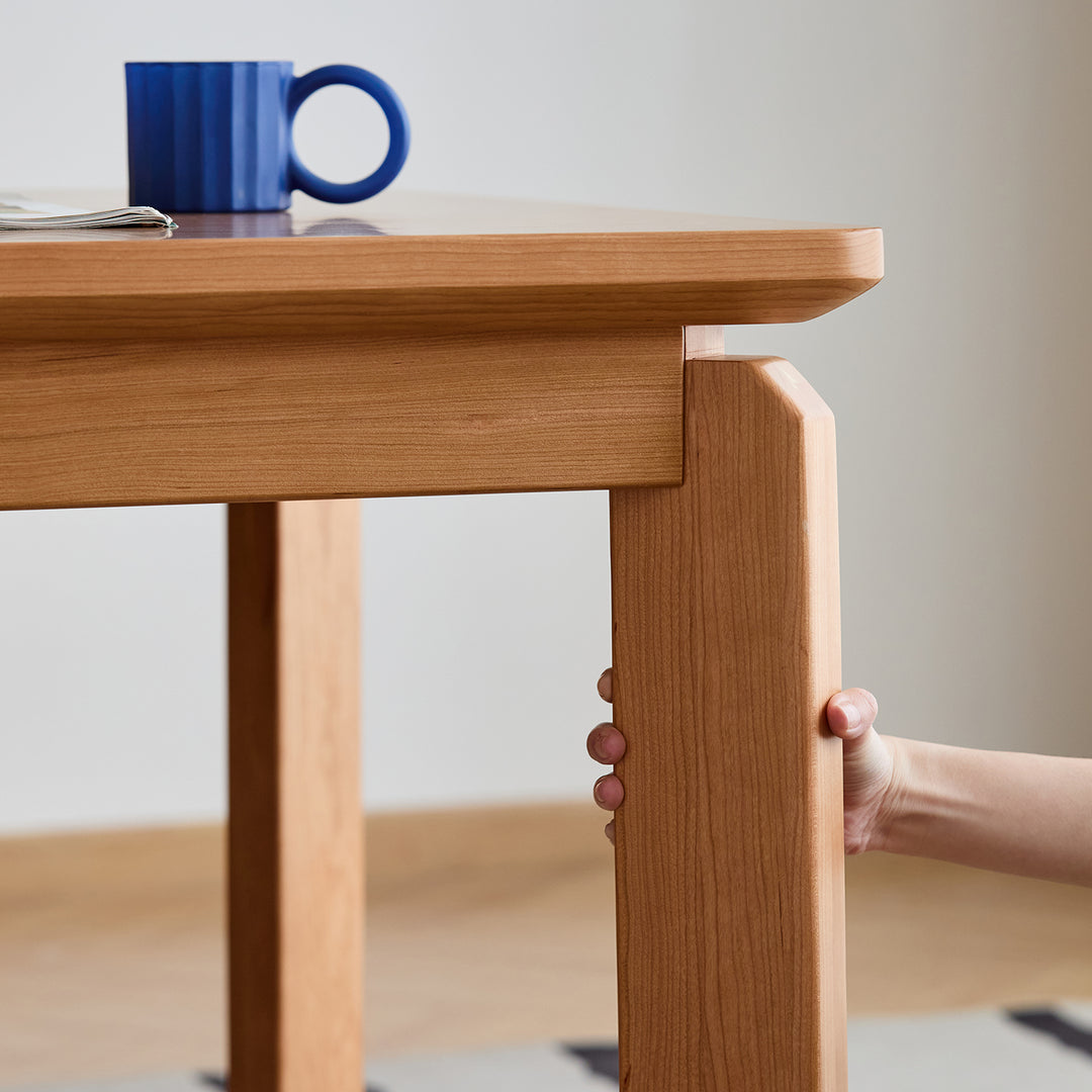 Scandinavian cherry wood dining table square in real life style.