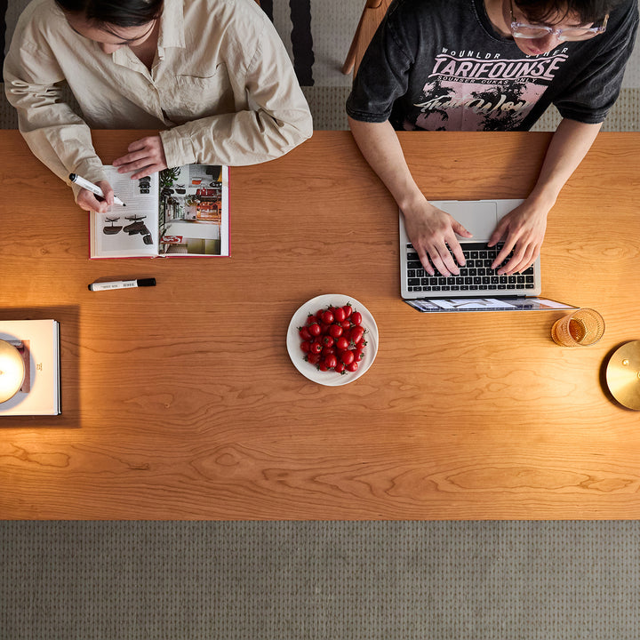 Scandinavian cherry wood dining table square in close up details.