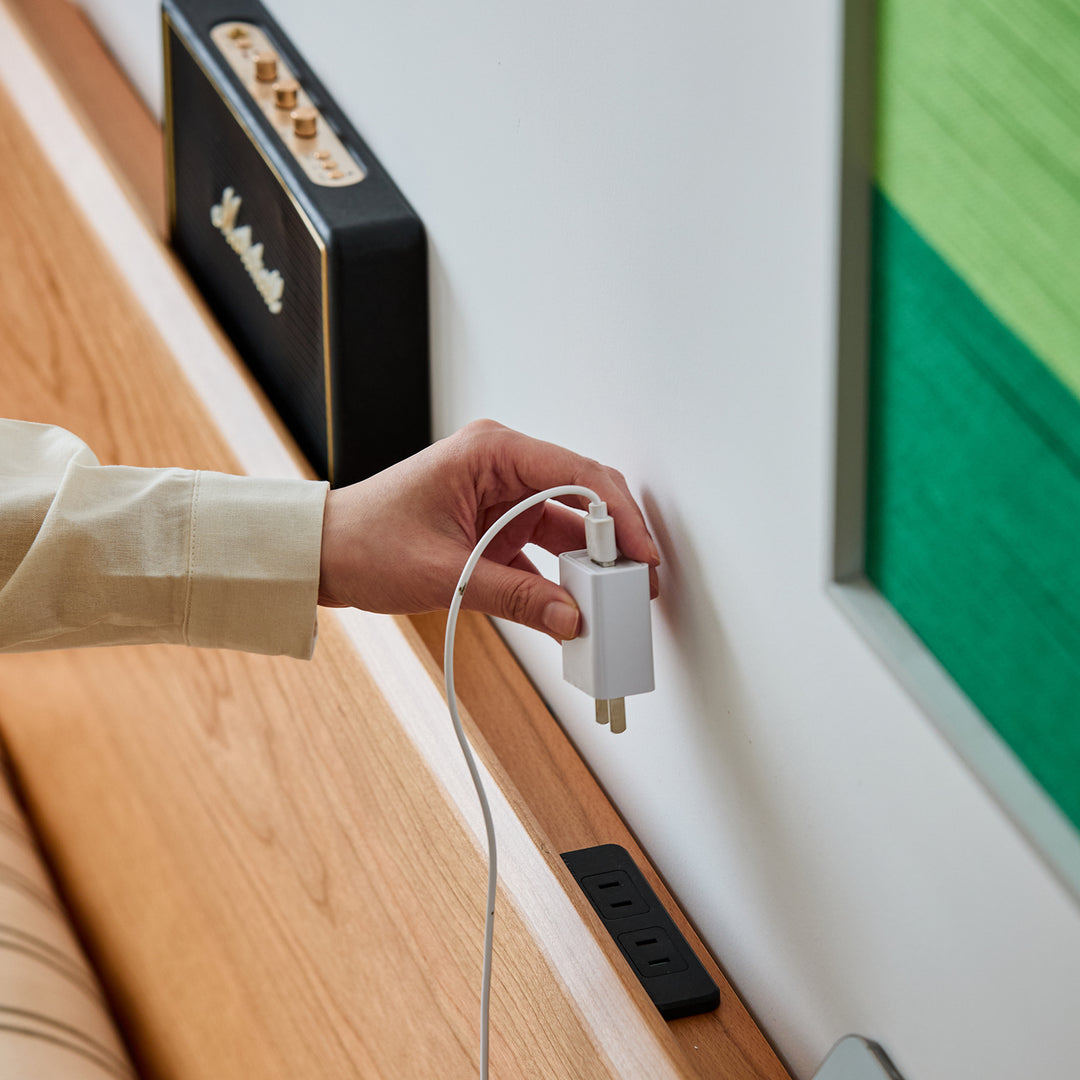 Scandinavian cherry wood lift-up storage bed square box in close up details.