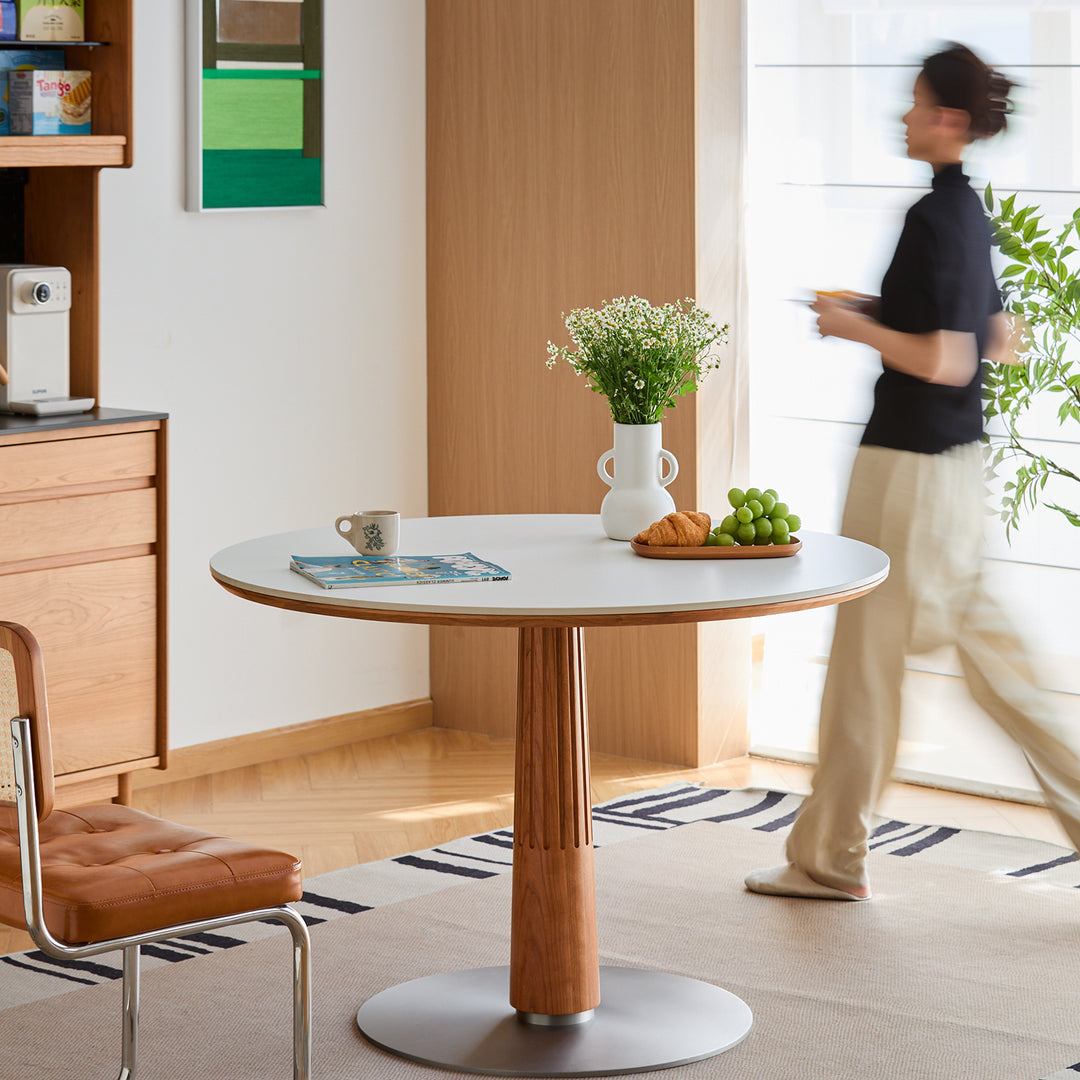 Scandinavian cherry wood sintered stone round dining table grey in close up details.