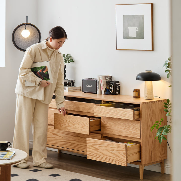Scandinavian oak wood chest of 8 drawers floating light in panoramic view.