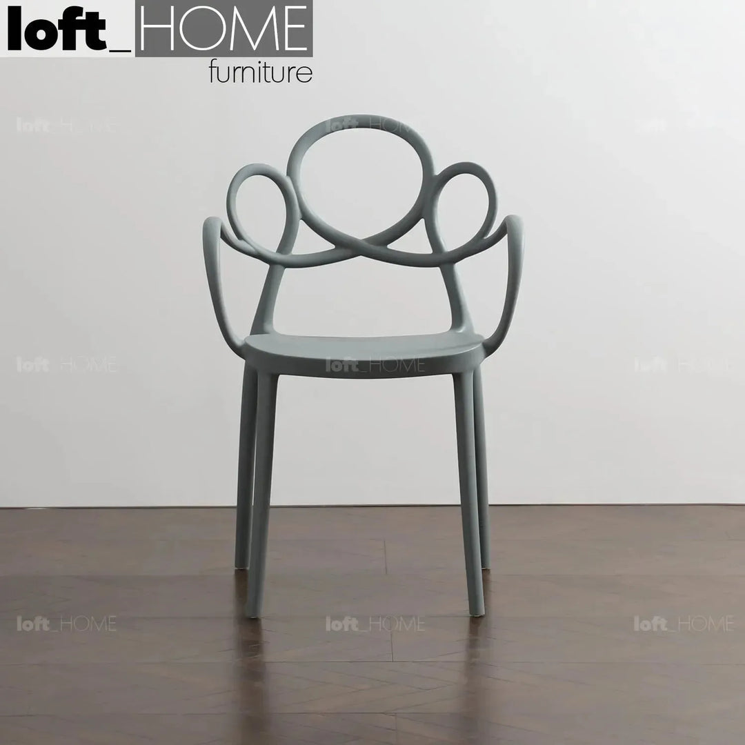 Contemporary plastic armrest dining chair mina in close up details.