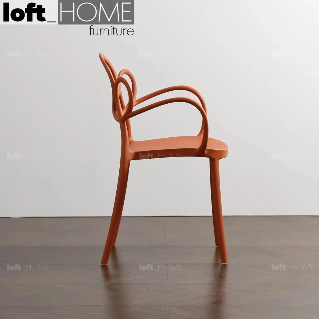 Contemporary plastic armrest dining chair mina in real life style.