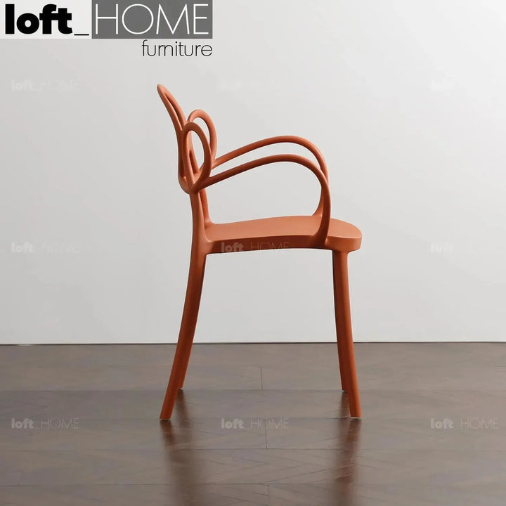 Contemporary plastic armrest dining chair mina in real life style.