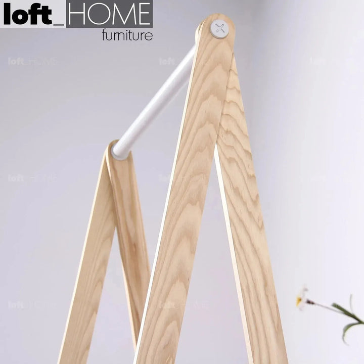 Modern wood cloth hanger toj in close up details.