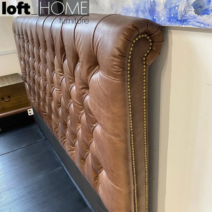 Vintage genuine leather bed frame chesterfield in close up details.