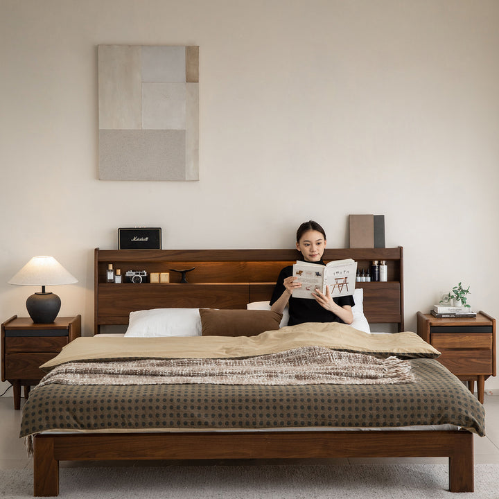 Vintage walnut wood bed accompany light with context.