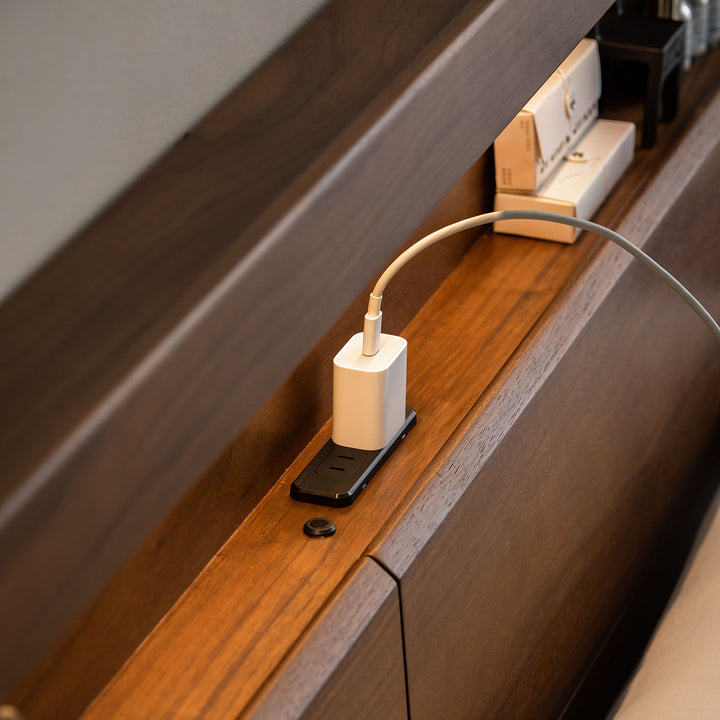 Vintage walnut wood bed accompany light in panoramic view.