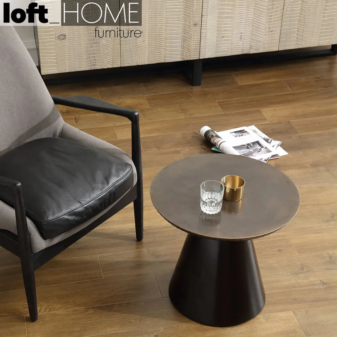 Vintage wooden round side table vintage brass in panoramic view.