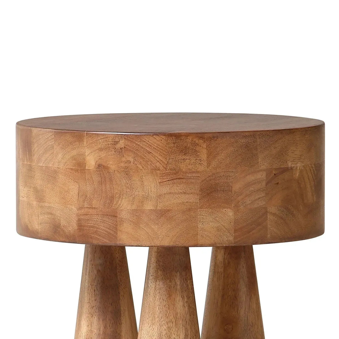 Rustic wooden side table stumpy with context.